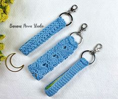 two crocheted keychains sitting next to each other