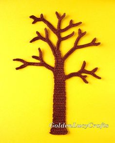 a crocheted tree is shown on a yellow background, with the shape of a leafless tree