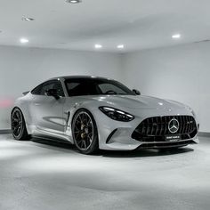 the mercedes amg gts is parked in a white room with black rims