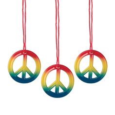 three peace signs hanging from strings on a white background