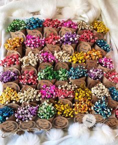 there are many different colors of beads on the white furnishce, and each is labeled with an individual's name