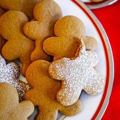 some cookies are sitting on a plate with powdered sugar