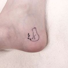 a small cat tattoo on the left side of the foot, which has an arrow in it