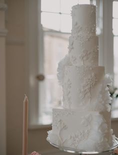 a white wedding cake sitting on top of a table