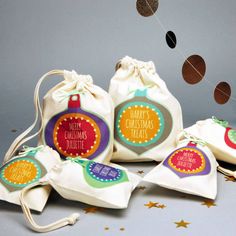 five bags with christmas ornaments hanging from them