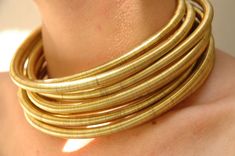 Gold African Metallic Tribal Choker, Coil, Necklace, Wire Wrapped, Cuff Necklace, Jewelry Neckrings, Collar, 1-8 Stacked Neckrings Set A special piece African Tribal Necklace made from gold wire, lightweight and easy to wear all day long!  You can choose the number of the rings you want in the variation, from two to six chokers.  more rings together have a more exciting result. The model in the first picture is wearing 6 neck rings. A special, unique Statement piece inspired from African beauty. African Choker, Cuff Necklace, Neck Rings, Neck Ring, African Accessories, Wrapped Necklace, Funky Jewelry, Wire Wrapped Necklace, Metal Accessories