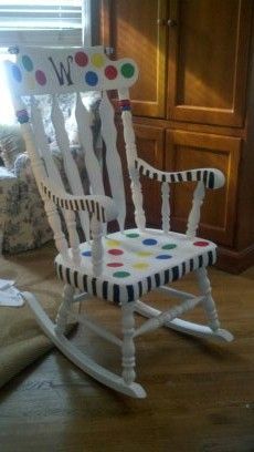 a child's rocking chair with polka dots on it