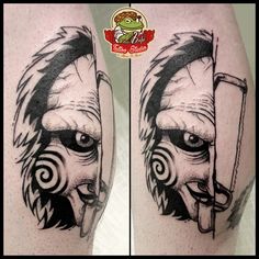 a tattoo on the leg of a man with an evil face