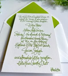 a green and white wedding stationery with calligraphy