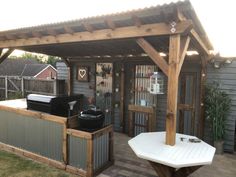 an outdoor bbq and grill area in a backyard