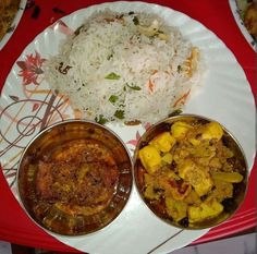 three different types of food are on a paper plate with red table cloth and silverware