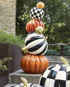 pumpkins are stacked on top of each other in the shape of checkered balls