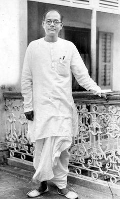 an old photo of a man standing on a balcony