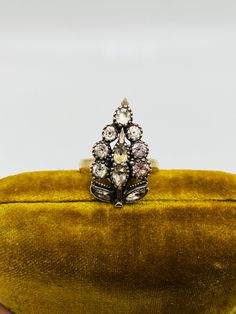 Stunning late 1700s Georgian black dot paste conversion ring featuring a cluster of glittering black dot paste gems set in sterling with rose gold accents on the stem. Depending upon how you turn this heirloom ring it looks like either a floral cluster or a bunch of grapes. This was an old brooch professionally converted into a ring. The current size is a 6.5. The band appears to be gold filled. There some solder where the brooch was attached to the band but it is in no way visible when the ring Heirloom Ring, Heirloom Rings, Bunch Of Grapes, Rose Gold Accents, Grape Bunch, Multi Stone Ring, Black Dots, Multi Stone, Cocktail Ring