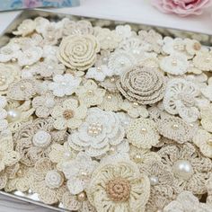 there are many crocheted flowers on the table