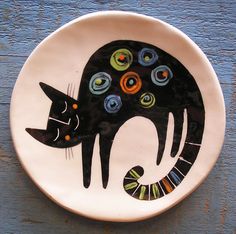 a plate with a black cat painted on it