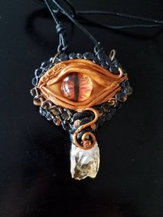 a close up of a necklace with an eye on it