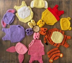 crocheted baby hats and mittens laid out on a table