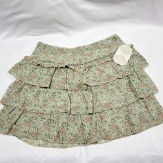 Mini Skirt Perfect For Spring. Self: 65% Rayon, 35% Polyester. Lining: 100% Polyester. Zipper At The Back. Match This With The Ivory Shoes Listed In "My Closet" Spring Green Skort With Ruffles, Green Ruffled Skort For Spring, Green Ruffled Skirted Skort, Green Ruffled Mini Skort, Green Flowy Mini Skirt With Ruffles, Flowy Green Mini Skirt With Ruffles, Green Flowy Ruffled Mini Skirt, Green Ruffled Tiered Skirt Skort, Green Pleated Tiered Mini Skirt