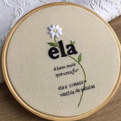 a cross stitch embroidery pattern with the words ela and a flower on it's side