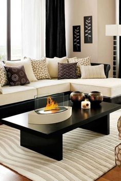 a living room filled with furniture and a fire place on top of a coffee table