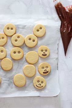 some cookies with faces are on a piece of paper