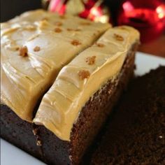 two slices of chocolate cake on a plate with christmas decorations in the backgroud