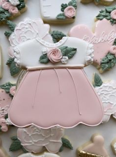 decorated cookies with pink and white designs on them