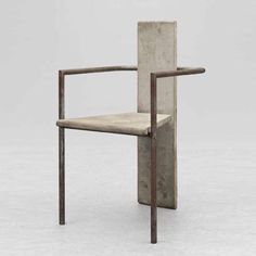 a chair made out of concrete with a wooden frame and arm rests on the ground