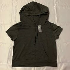 A Short Sleeve Hoodie, But Thinner Like A T-Shirt. New With Tags. I’m Open To Most Offers, Just Leave A Comment Down Below <3 And If You Need Additional Pictures, Measurements, Etc. Feel Free To Ask And I’ll Edit The Listing :)) Casual Solid Color Hooded Top, Casual Cotton Hooded T-shirt, Casual Hooded Relaxed Fit T-shirt, Stretch Crew Neck Top With Drawstring Hood, Urban Short Sleeve Tops For Winter, Basic Loungewear Top With Drawstring Hood, Trendy Hooded Top With Drawstring, Trendy Solid Top With Drawstring Hood, Trendy Solid Color Tops With Drawstring Hood