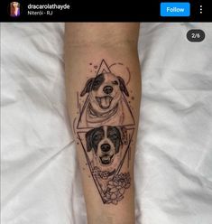 two dogs are shown on the arm and behind them is a triangle with flowers in it