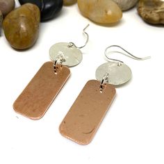 If you are looking to add a special touch to your outfit, or you need a unique gift, these handmade copper and sterling silver earrings would be perfect. Because of their sleek design, they are great to be used at work or to go out with friends. These earrings are perfect to indulge yourself or as a gift to give joy to someone else. The earring drop length is 2 inches and the width is 0.5 inches * Similar design with patina: https://www.etsy.com/listing/921888435 * To check other designs in the shop go to https://www.etsy.com/shop/LittleYellowRoomShop * Packing: Your order will be packed and ready to be presented as a gift. If you are sending it to someone else I will include a gift note from you. Just let me know what you'd like the note to say. * Photography: I do my best to photograph e Hammered Copper Earrings For Gift, Silver Electroformed Earrings, Minimalist Silver Copper Earrings, Artisan Nickel-free Rose Gold Earrings, Artisan Rose Gold Nickel-free Earrings, Electroformed Dangle Earrings For Gifts, Minimalist Electroformed Earrings For Gift, Electroformed Rose Gold Dangle Earrings, Mixed Metal Earrings