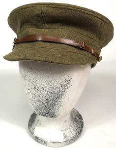 a hat is sitting on top of a mannequin's head, wearing a brown leather band around the brim