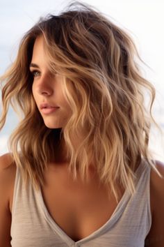 Medium-length layered hairstyles are the best of both worlds, meaning long and short cuts. They offer all the same vibrancy of a short, trendy cut with a #mediumlengthhaircut Medium Length Haircut Textured Layers, Beachy Haircut Mid Length, Fine Hair Beach Waves, Beachy Lob Haircut, Beach Photo Hairstyles, Shoulder Length Hair Blonde Layers, Short Beachy Haircut, Medium Length Naturally Wavy Hair, Medium Length Haircut Dirty Blonde