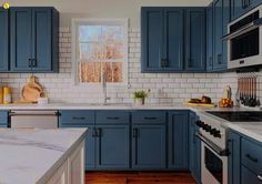 a kitchen with blue cabinets and white counter tops