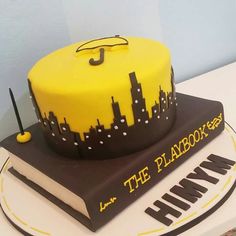 a cake that is sitting on top of a book with the words the playbook