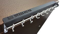 the name steelhead is attached to a metal door handle on a brown and black cabinet