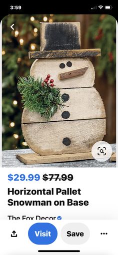 a wooden snowman sitting on top of a table