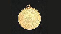 a gold medal with an eagle on the front and back side, is displayed against a black background