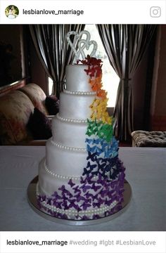 a white cake with rainbow decorations on it