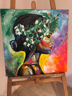 a painting on an easel with flowers in it