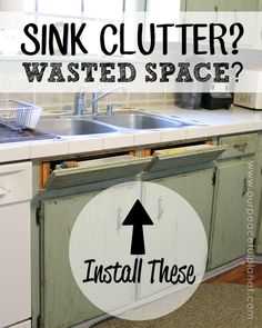 a kitchen with sink clutter on the counter top and an arrow pointing to it