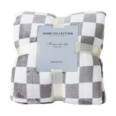 a white and grey checkered pillow with a tag on it that says home collection