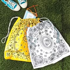 an article in the paper shows three bags with designs on them and two pairs of tennis shoes