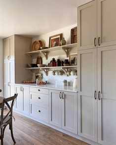 the kitchen is clean and ready for us to use it's white cupboards