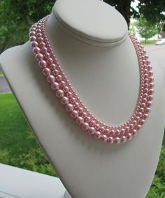 Graduated Pearl Necklace Set ~ This elegant pink pearl necklace set is made with 3 sizes of medium blush pink pearls. A very simple piece to add accent to your wardrobe without overpowering it; whether you are a bride walking down the aisle, or a woman getting ready for a day at the office.  The pink pearls mimic Sarah Jessica Parker's piece, as shown in the last picture and has a classic Jackie O vibe to it.  Earrings shown are included and measure approximately 1".This graduated pink pearl nec Pink Pearl Chain Necklace For Wedding, Pink Pearl Single Strand Jewelry, Pink Single Strand Pearl Jewelry, Feminine Pink Pearl Necklace For Wedding, Pink Round Bead Pearl Necklace For Wedding, Pink Round Beads Pearl Necklace For Wedding, Pink Pearl Single Strand Necklace, Pink Pearl Necklace With Round Beads For Wedding, Pink Single Strand Pearl Necklace