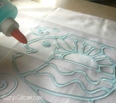 someone is using glue to create an intricate design