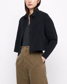 A thoughtfully tailored shirt jacket. Features a generously boxy fit, cropped length, dolman sleeves and a button placket. Paneled construction and a pleated hem. + Details Color: Black 100% Cotton XS, S, M, L Julie is 5’9” and wearing a S Hand wash cold, lay flat to dry. Can be machine washed cold. Do not tumble dry. Can be dry cleaned. + Material A sturdy heavyweight cotton twill reminiscent of workwear canvas. Resilient and easy to care for. Features a luxuriously smooth surface and a slight Classic Collared Cropped Jacket For Work, Button-up Cropped Jacket For Work With Button Cuffs, Oversized Lapel Collar Top For Business Casual, Collared Cropped Jacket With Button Cuffs For Work, Oversized Tops With Lapel Collar For Business Casual, Cropped Button-up Jacket With Hidden Button Closure For Workwear, Modern Cropped Jacket With Long Sleeves For Work, Modern Long Sleeve Cropped Jacket For Work, Modern Cropped Jacket For Workwear