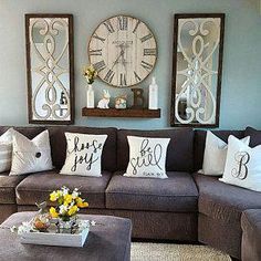 a living room filled with lots of furniture and pillows on top of a rug next to a coffee table