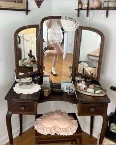 a woman is standing in front of a vanity with her legs up on the table